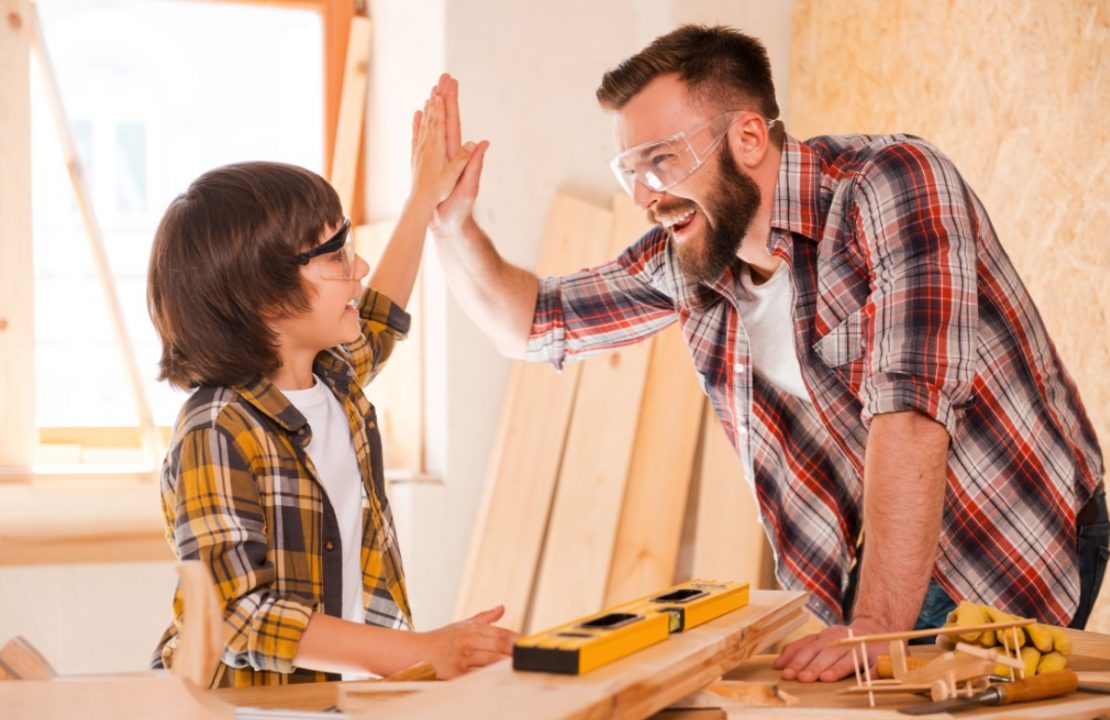 Man High Fiving Child