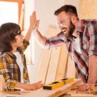 Man High Fiving Child