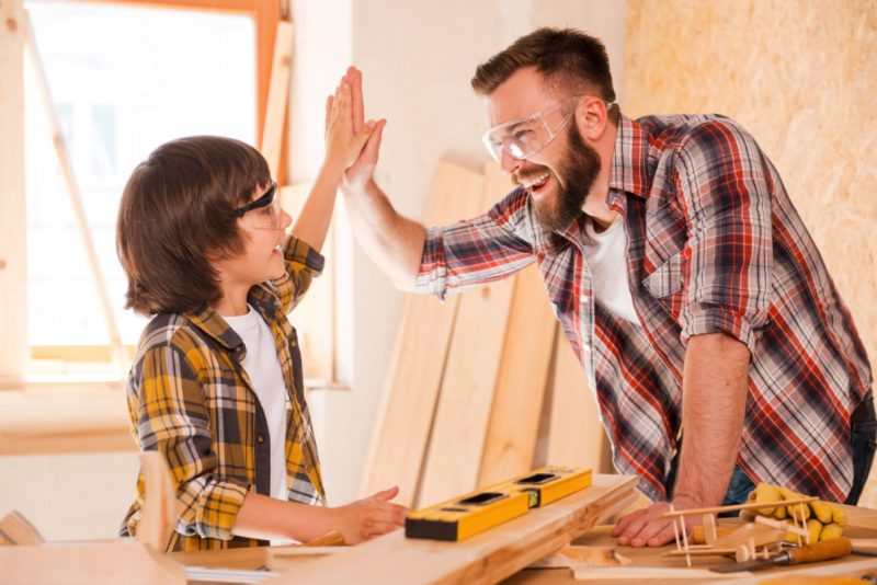 Man High Fiving Child